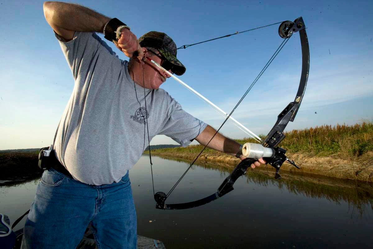 Man fishing with crossbow