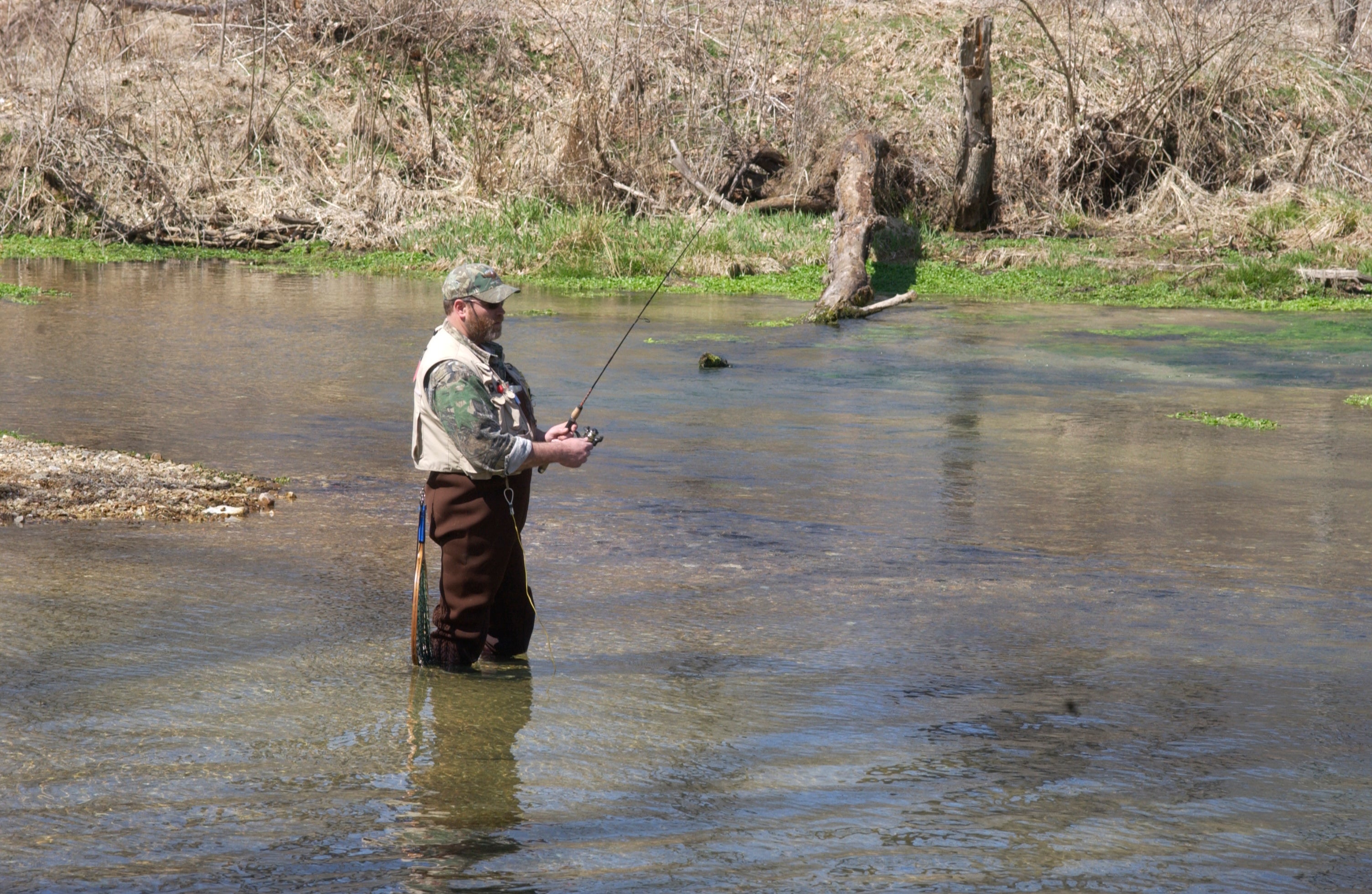 Trout angler fishing in a stream