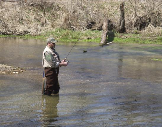 Trout angler fishing in a stream