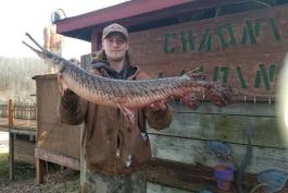 Devlin Rich holds his world record pole and line spotted gar